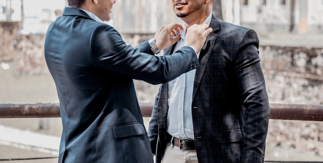 two friends shaking hands after disagreement