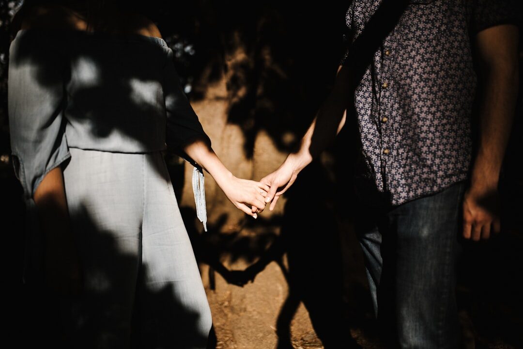 couple holding hands at event