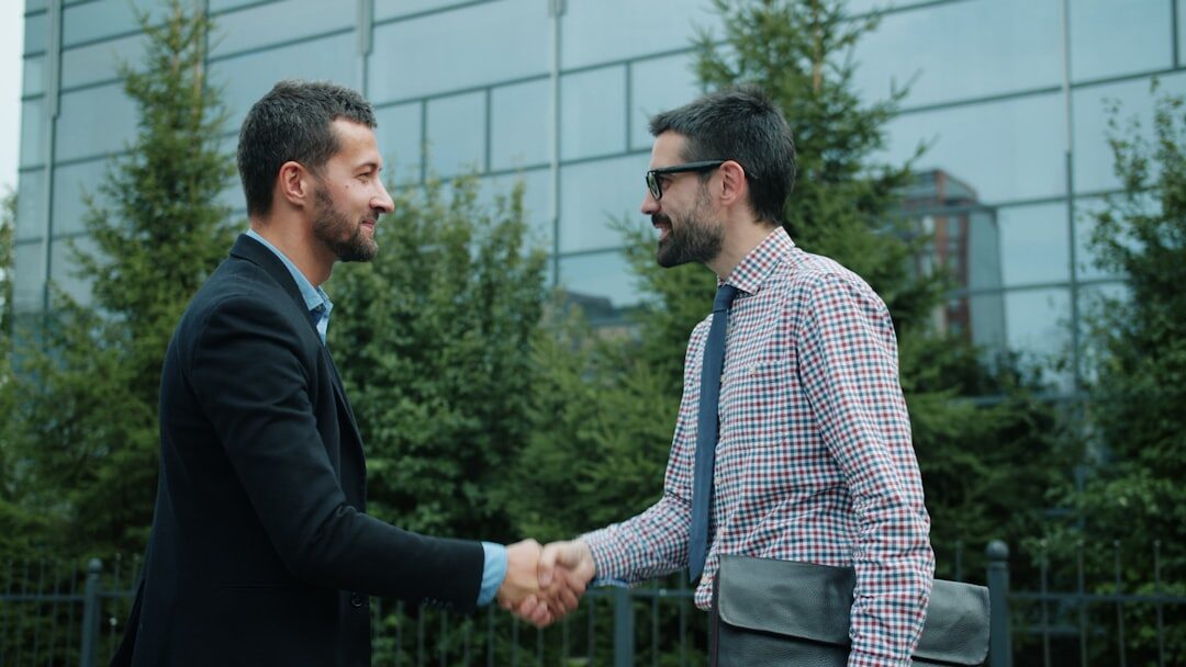 two people shaking hands after disagreement