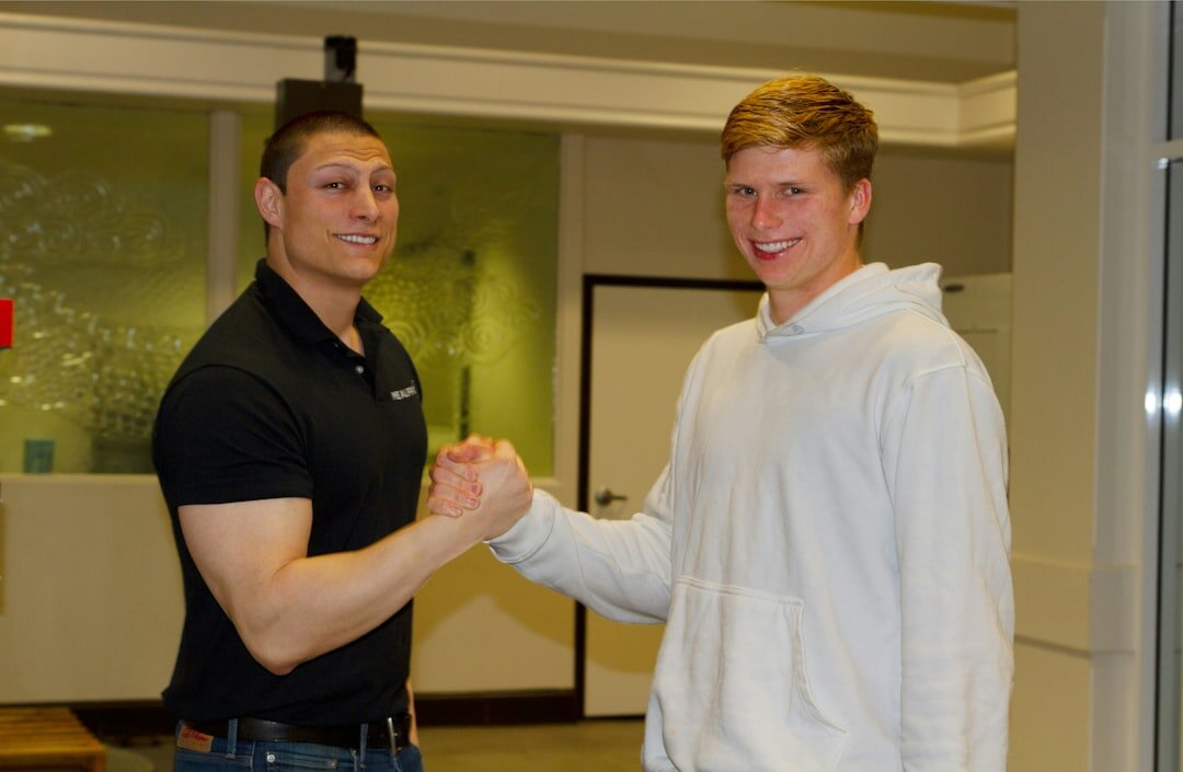 two celebrities shaking hands