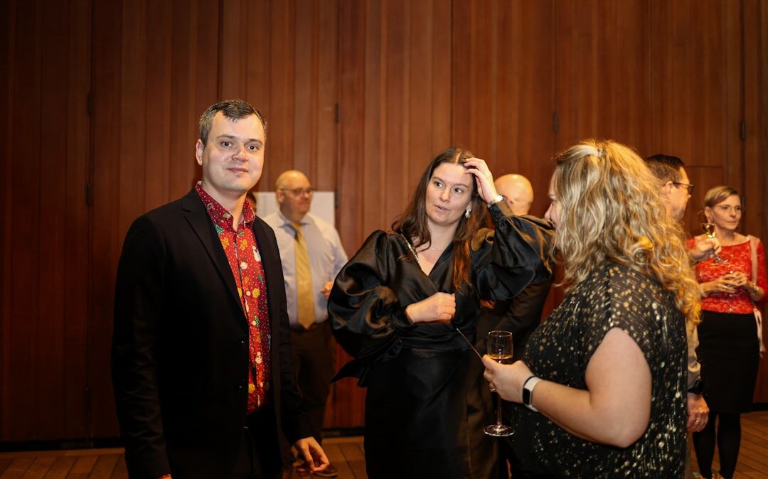 two celebrities shaking hands at gala
